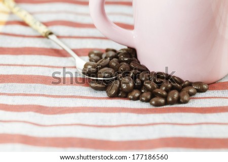 Coffee beans and a cup