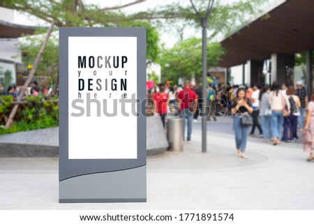 Blank white screen city sale advertisement billboard lightbox mockup. Street poster advertisement light board mock up with blurred people on the shopping street background.