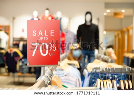 Sale label stand template on shelve in male clothing store for sale promotion and discount information for Black Friday and Holiday season. Banner template mockup. Discount sale 70% red sign Royalty-Free Stock Photo #1771919111