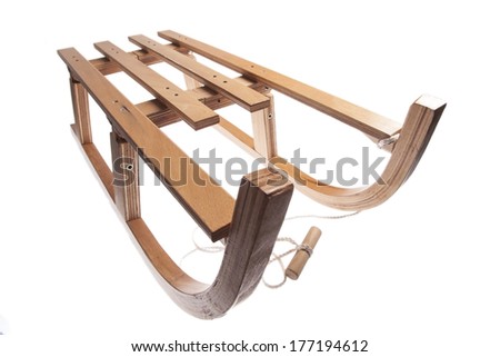 Color picture of a vintage wooden sledge isolated on white