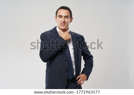 confident businessman adjusting shirt collar finance model