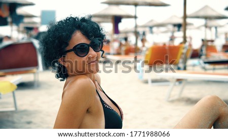 Beautiful woman with glasses enjoy summer vacation on beach and smile to camera