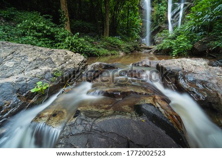 Tropical waterfall in rain forest at Mokfa Waterfall, Chiang Mai in North Thailand.