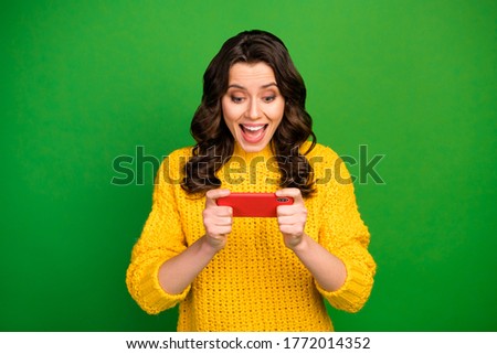 Portrait of surprised crazy girl use smartphone browse internet impressed by fast speed connection scream wow omg wear jumper isolated over bright shine color background