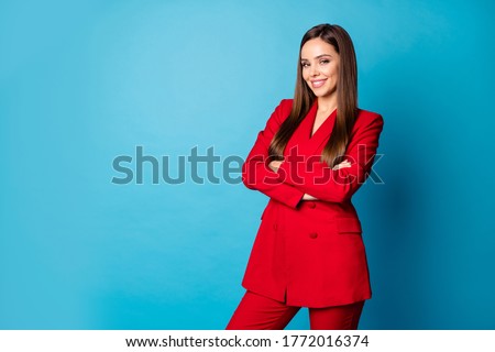 Photo of attractive cool self-confident business lady hold arms crossed toothy smiling standing bossy wear red luxury office blazer trousers suit isolated blue color background