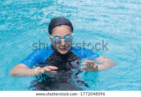 Asian woman are happy to relax
 by swimming on summer vacation.