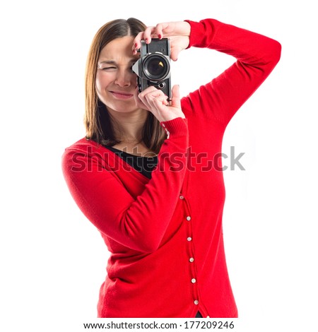 Girl taking a picture over white background 