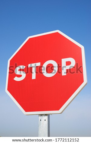 Stop traffic sign with clear blue sky.