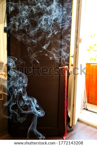 Smoke on the background of a door in a sunlit room