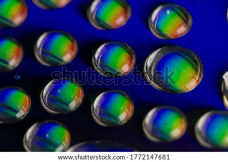 Macro shot of water drops on a CD surface for an abstract background.