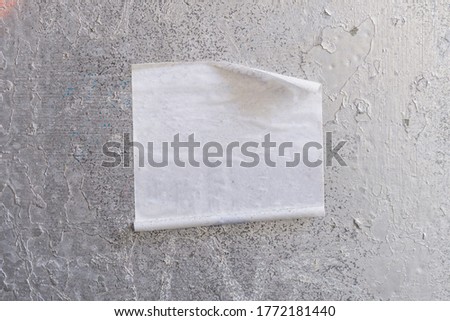 Square blank sticker mockup on the street glued to the wall. White textured label template.