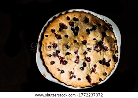 the process of making homemade pie with berries. The batter is poured into a baking dish. Homemade sweets, homemade pie