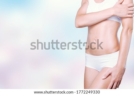 Figure of slim attractive female with a flat belly in white underwear.
