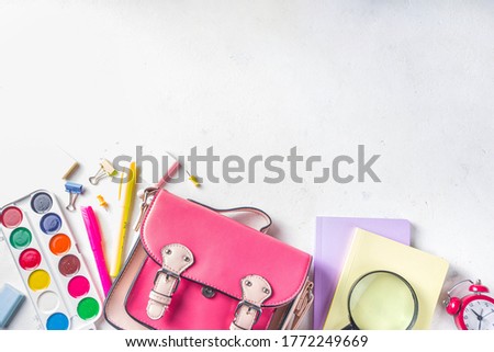 Back to school, education background. Back to School White Background with School Bag Backpack, Notebook, Pen, Pencil, Pencils, Magnifying Glass, Eraser, Paper Clip, Alarm Clock, School Supplies 