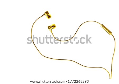 Golden wired earphones isolated on white background