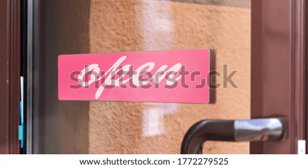 open sign in red frame on glass door of store outdoor business retail concept