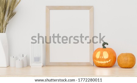 Mock up poster or photo frame on table with halloween decoration.