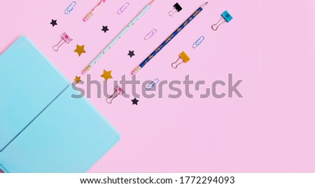 School supplies flatlay on pink background. Back to school. School 2020. School banner with planner, book, clips, pen, stars, binder clips. Space for text. Place for text. Business banner background