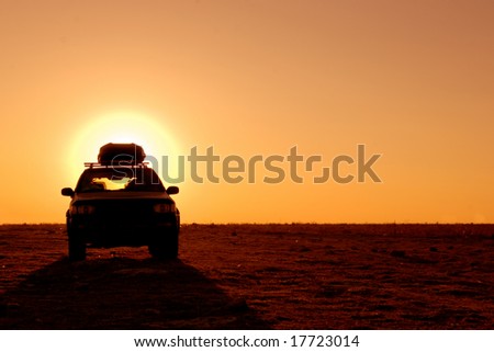Offroad 4x4 vehicle in the desert at sunrise Royalty-Free Stock Photo #17723014