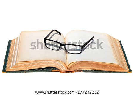 Open ancient book with empty pages and glasses in a classical black frame isolated on the white background