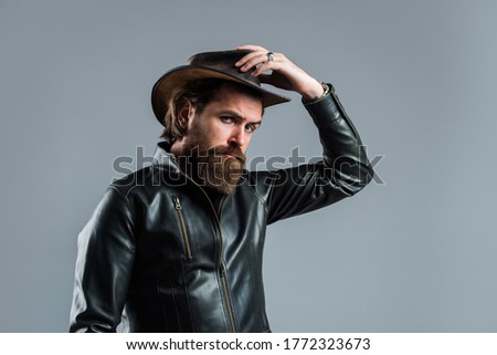 Cowboy style. fashionable man dressed in leather jacket. west fashion model. handsome man in cowboy hat. serious bearded biker. stylish mature man looking modern. mens western wardrobe.