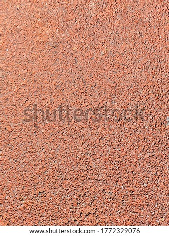The surface of the rubber coating used in children's and sports fields. Background and texture.