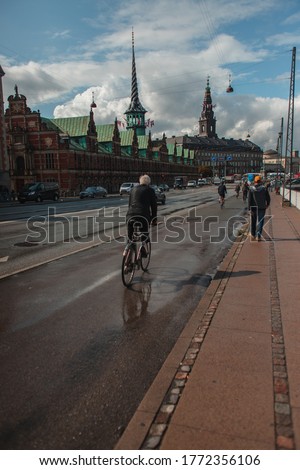 People on urban street with Christiansborg Palace at background in Copenhagen, Denmark