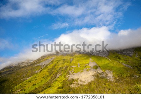 Beautiful mountain peak in the clouds. Nature of Norway. Senja Island Europe