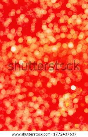 Bright golden bokeh on red. Defocused abstract background. Yellow Boke texrure.