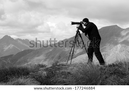 Professional content creator creating travel, nature, landscape, wildlife photography and filming video footage content in the wilderness outdoor of South Island of New Zealand. Real people.Copy Space
