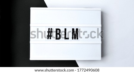 hashtag BLM BLACK LIVES MATTER text on a black and white background. Freedom of Speech Vintage Retro quote board. Protest against the end of racism, anti-racism, equality. Poster on violation of human