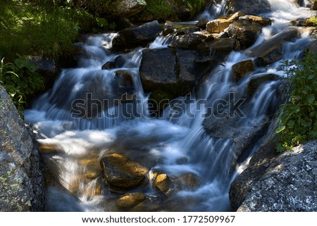 Waterfalls among the rocks of a small river