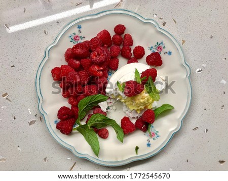 Fresh Raspberries with Pavlova Cake Filled with Lemon Cream / Meringue Dessert.