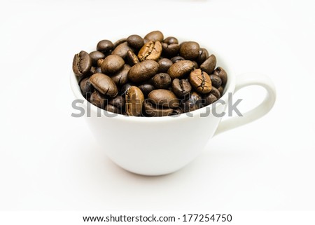 Fresh coffee beans in a white cup with white background 