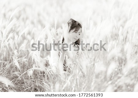 Woman posing in front of pampas grass