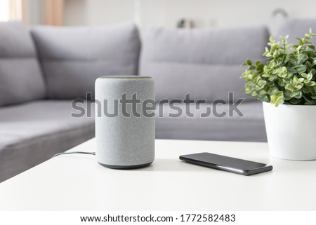 Smart speaker device in living room. Intelligent assistant in smart home system. Royalty-Free Stock Photo #1772582483