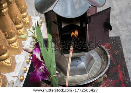 Pictures of incense, candles to fire, in a lamp with a fire, with flowers beside