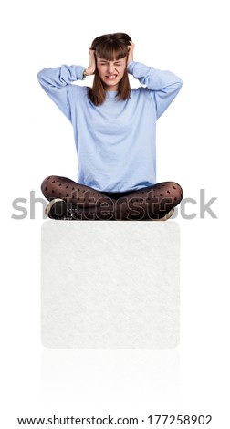 young woman covering her ears sitting on a box