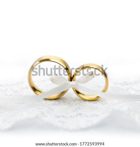 Light Wedding Celebration background - pair of wedding rings with bow