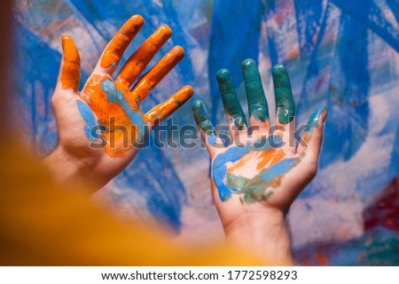 Artist painted hands in art workshop. Modern artwork paint on canvas, creative, contemporary and successful fine art artist drawing masterpiece