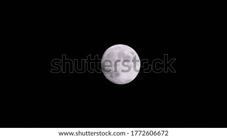 Full moon. The moon is an astronomical body full of metal against a dark universe background.