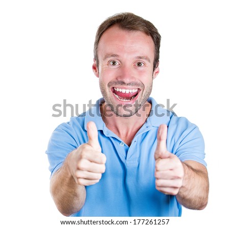 Closeup portrait of handsome super happy excited young smiling man giving two thumbs up sign at camera isolated on white background. Positive human emotion, facial expression, feelings. Symbols, signs