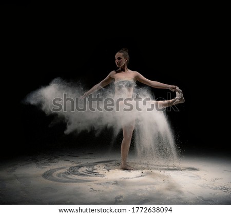 Graceful lady in underwear pose in yoga asana with dust