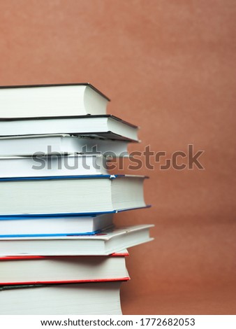 a stack of books on a brown background. High quality photo.