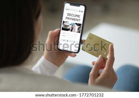 Close up back view of woman shopping online on smartphone using credit card, female enter Internet banking system on cellphone, make payment purchase on gadget, paying bills on web, screen mockup Royalty-Free Stock Photo #1772701232