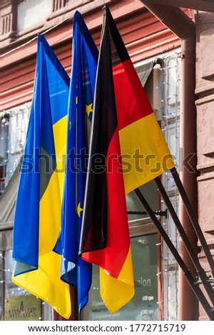 Three flags hang on the wall: Germany, the European Union and Ukraine.