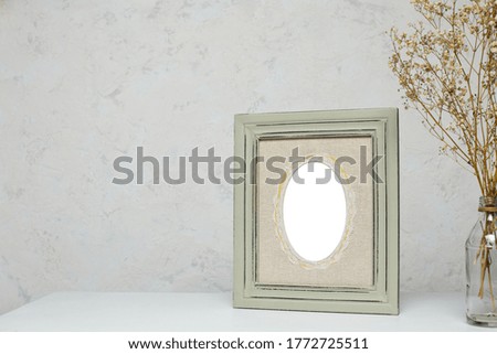 vintage blank frame mockup with flowers on white table