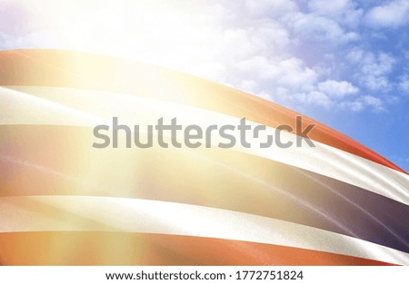flag of Thailand against the blue sky with sun rays