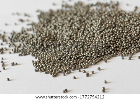 View of the circular steel grits on the paper for abrasive or sandblasting. Steel grits are produced by fracturing high carbon steel balls after heat treatment. Steel grits have high resistance. Royalty-Free Stock Photo #1772754212