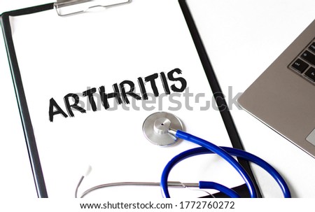 word Arthritis on the paper plate with laptop, Medical concept